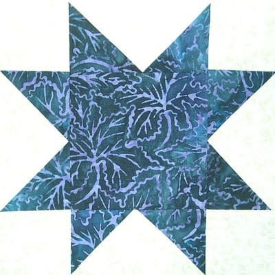 Blue colored sawtooth star quilt block in white background